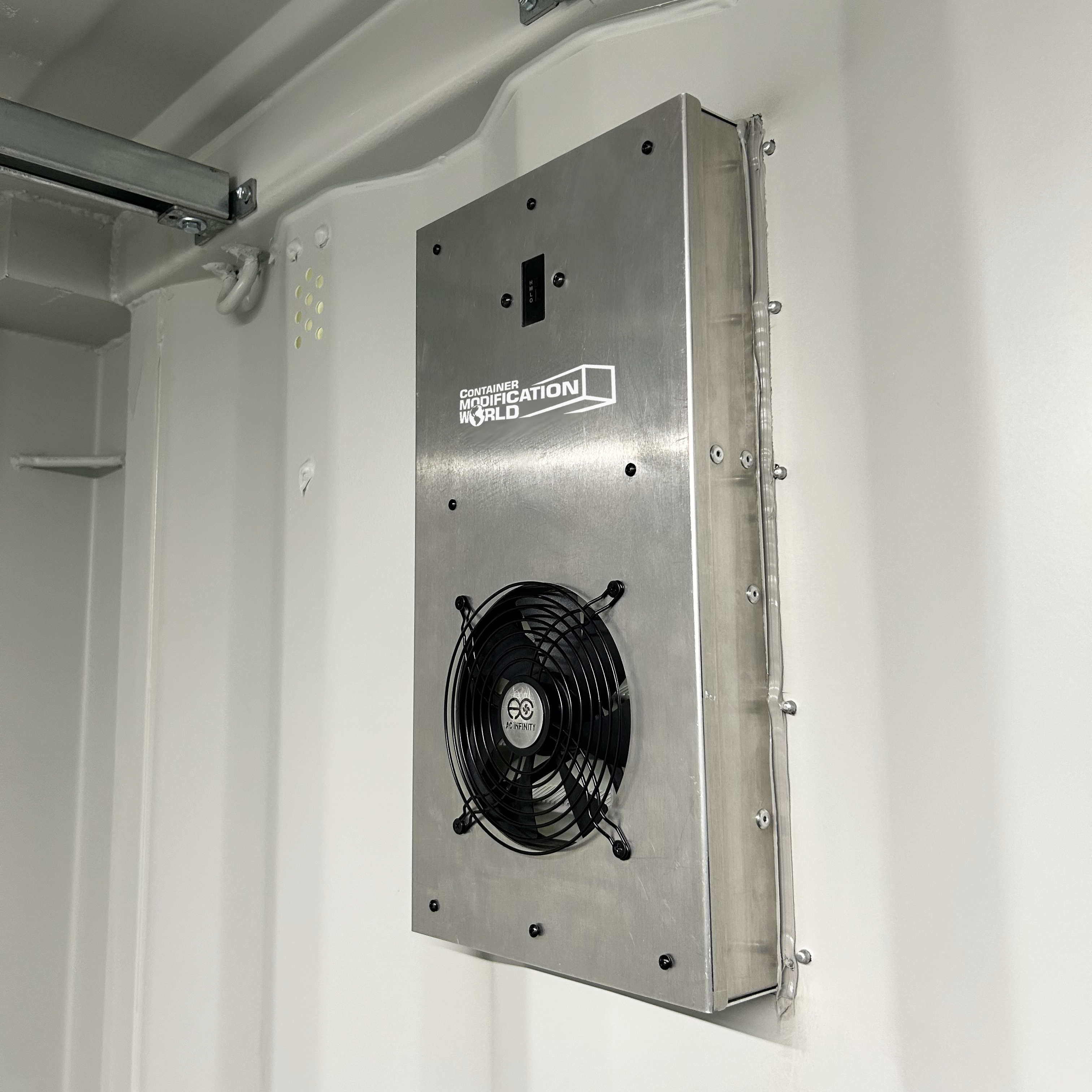 BigAir 57 CFM solar vent view of the product installed on the interior side of a shipping container wall, showing the vent grille and fan assembly to improve airflow and reduce moisture buildup.