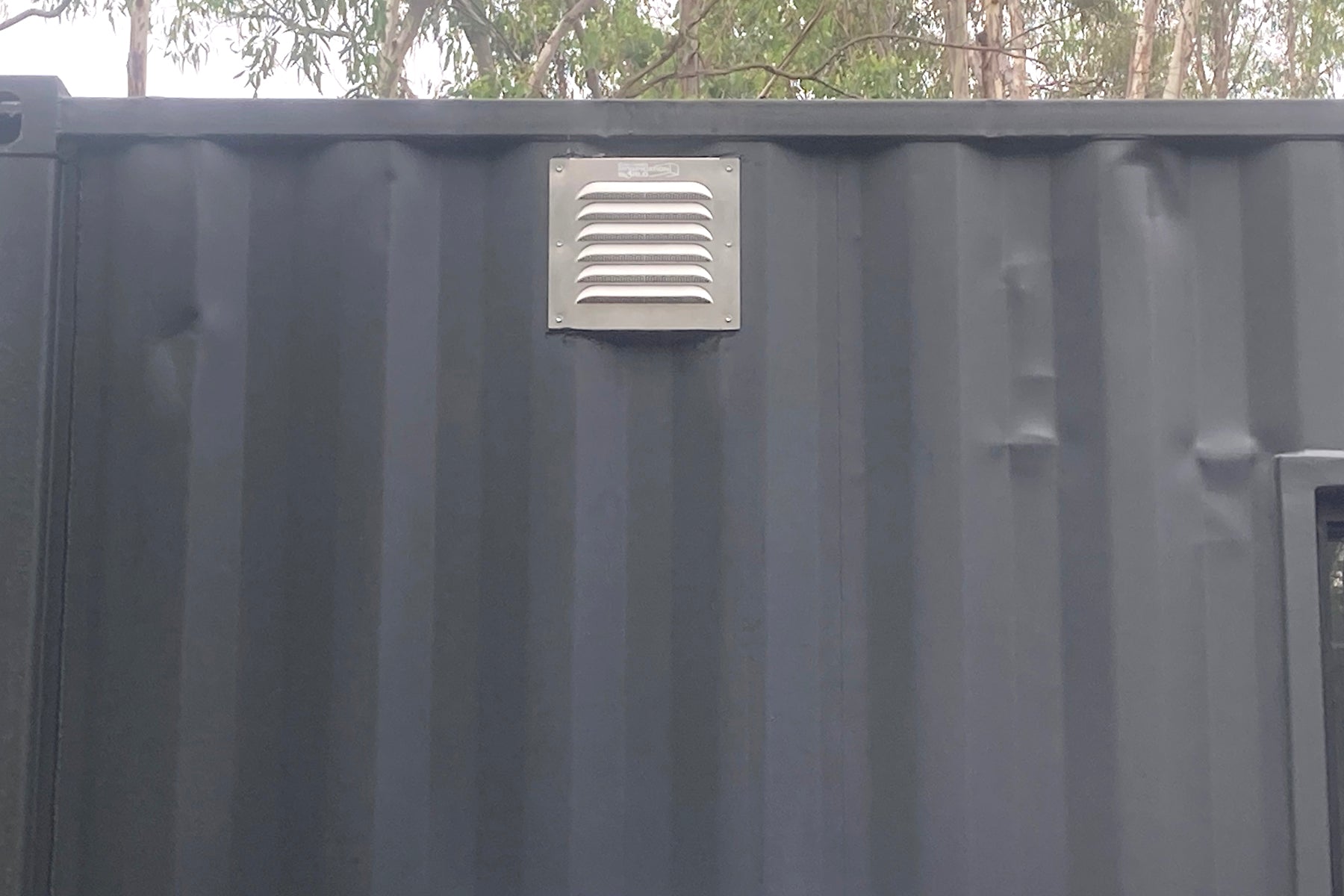 BigAir30 louvered vent installed on side wall of shipping container between corrugations